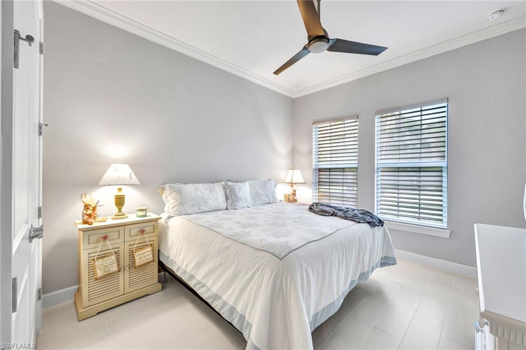 10163 Coconut Road Estero, FL 34135 - Photo 25 of 44 a bedroom with a bed and a chandelier
