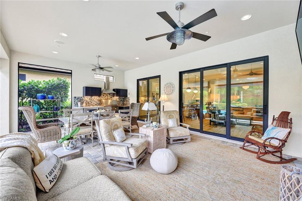 10163 Coconut Road Estero, FL 34135 - Photo 29 of 44 a living room with furniture and floor to ceiling window