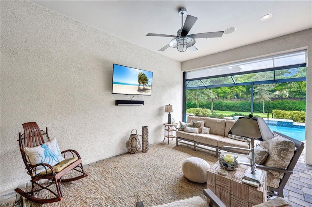 10163 Coconut Road Estero, FL 34135 - Photo 32 of 44 a living room with furniture and a floor to ceiling window