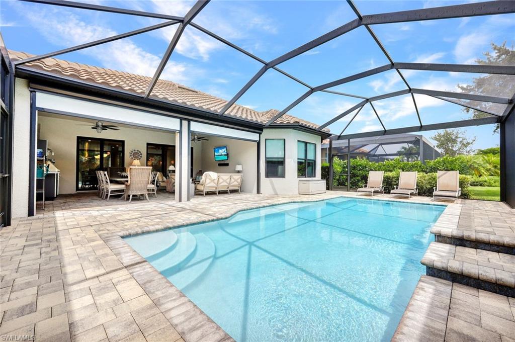10163 Coconut Road Estero, FL 34135 - Photo 34 of 44 a view of a patio with a table and chairs under an umbrella