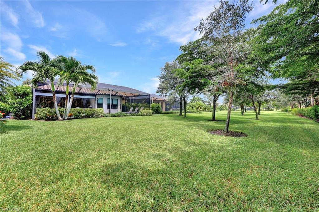10163 Coconut Road Estero, FL 34135 - Photo 38 of 44 a view of a house with a big yard