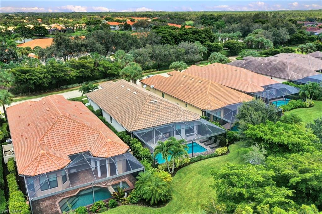 10163 Coconut Road Estero, FL 34135 - Photo 40 of 44 an aerial view of a house with a yard and lake view