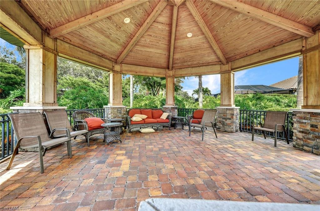10163 Coconut Road Estero, FL 34135 - Photo 42 of 44 a view of a patio with table and chairs under an umbrella