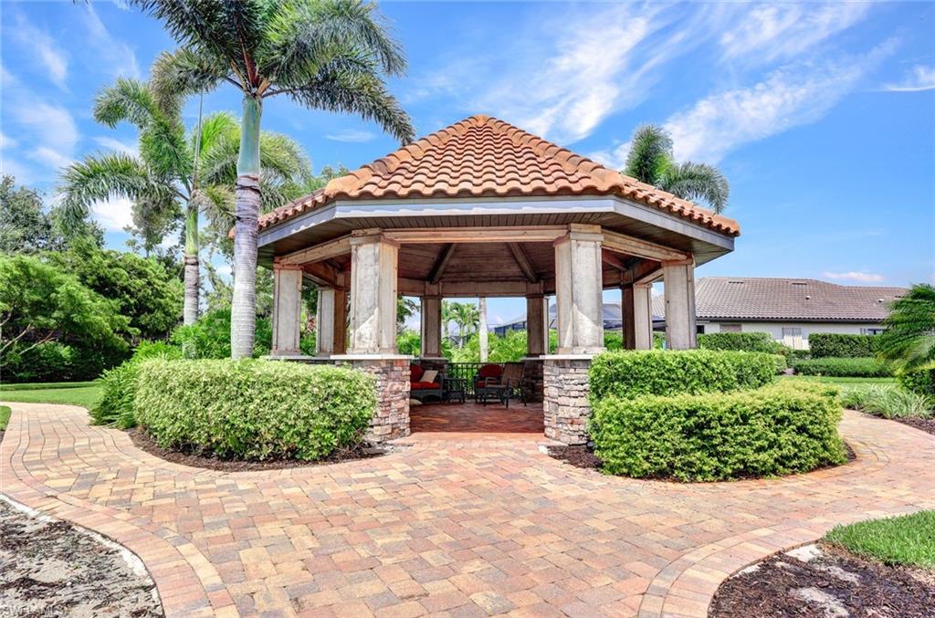 10163 Coconut Road Estero, FL 34135 - Photo 43 of 44 a front view of a house with garden