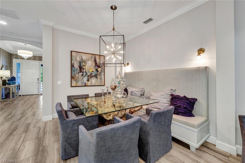 10163 Coconut Road Estero, FL 34135 - Photo 6 of 44 a dining room with furniture and wooden floor