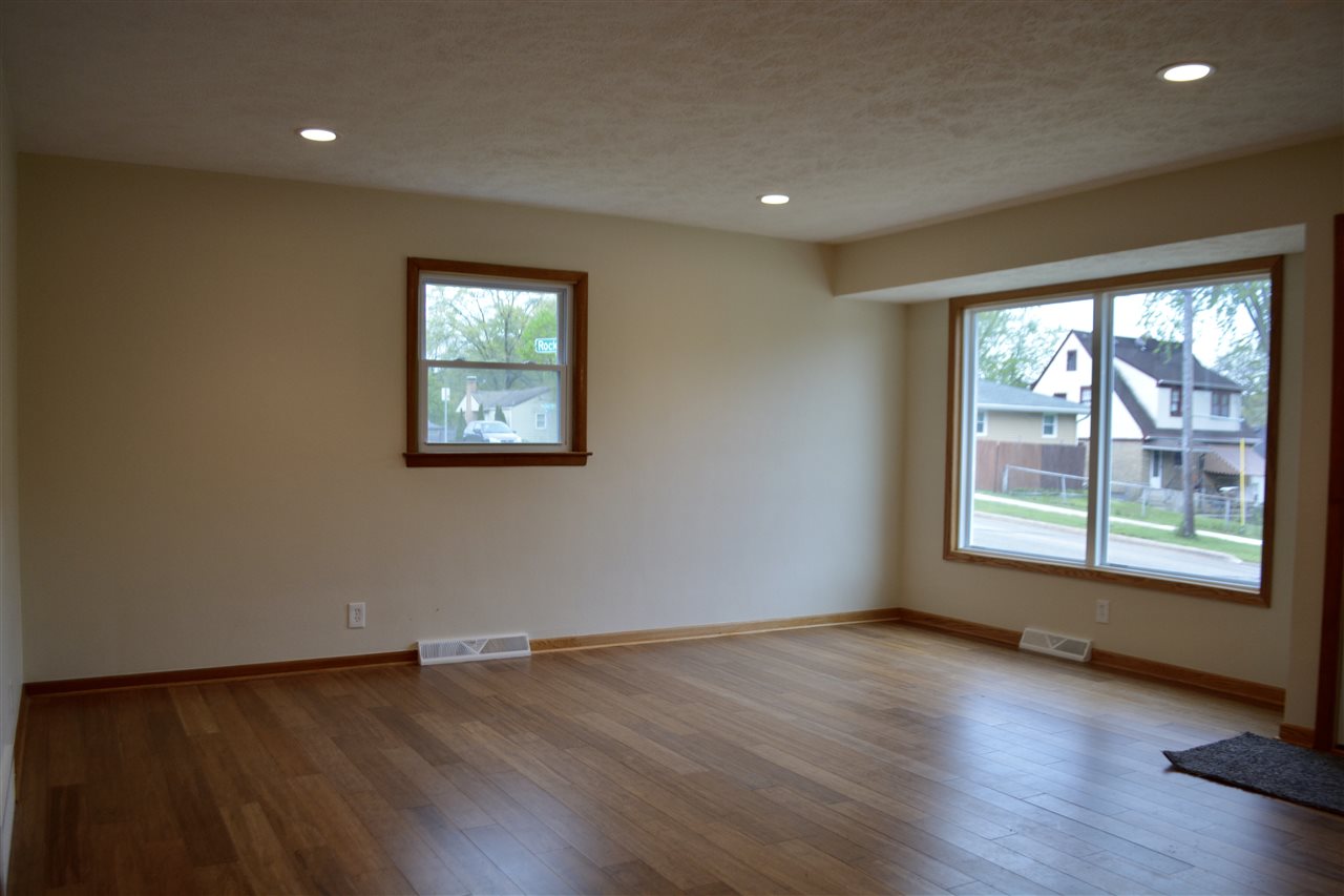 2224 Rural Street Rockford, IL 61107 - Photo 3 of 15 an empty room with wooden floor and windows