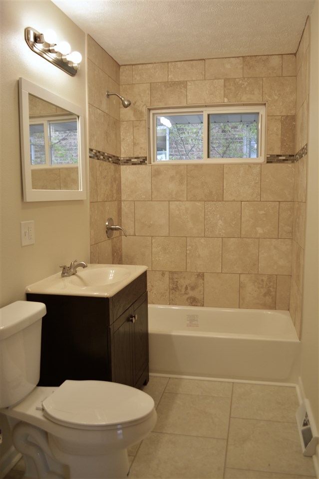 2224 Rural Street Rockford, IL 61107 - Photo 7 of 15 a bathroom with a sink a toilet and shower