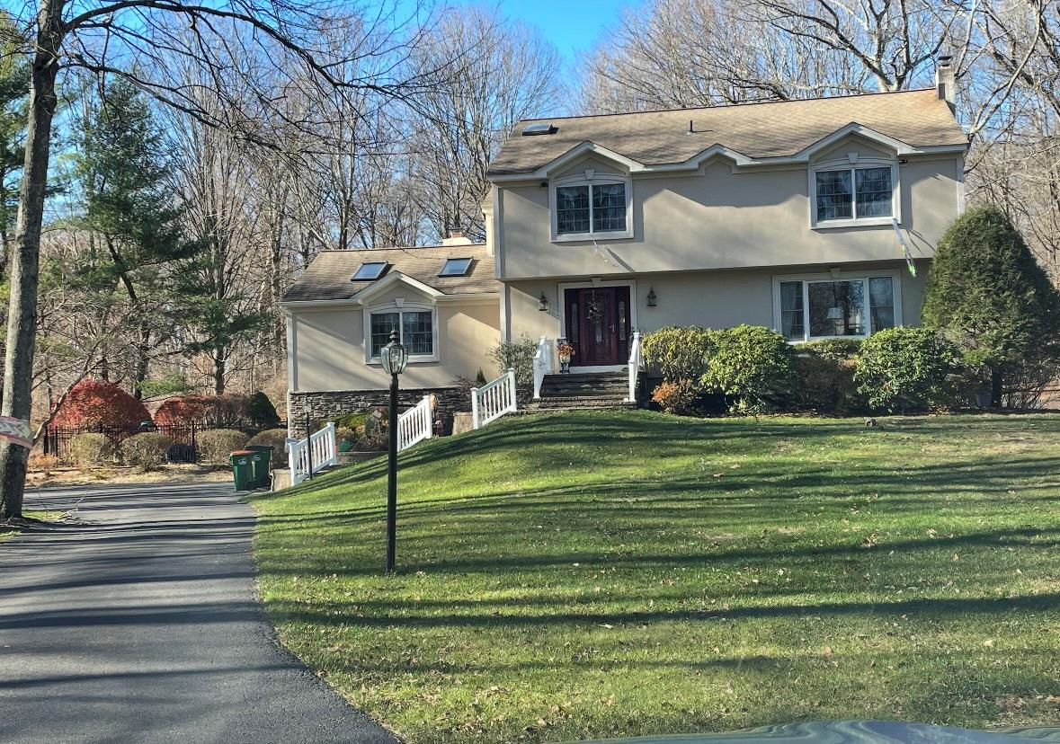 a front view of a house with a garden