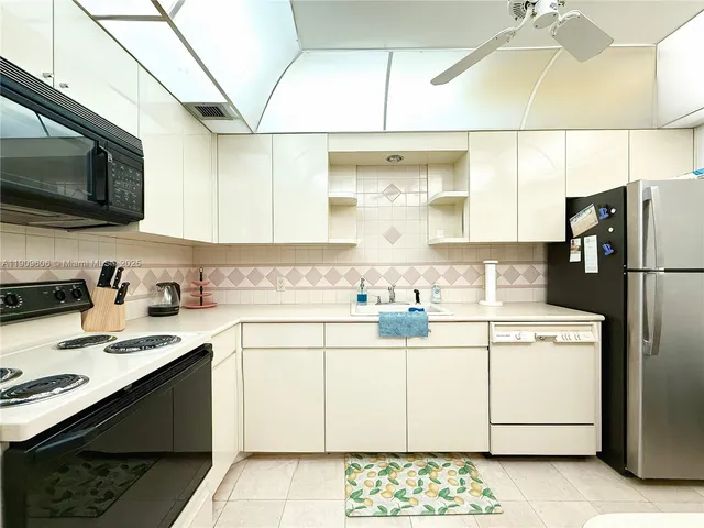 a kitchen with a sink a stove and refrigerator