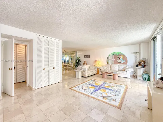 a living room with furniture a rug and a table