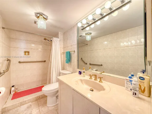 a bathroom with a sink vanity mirror and toilet