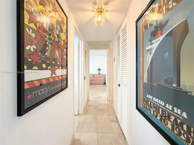 a view of a hallway to a livingroom with furniture and staircase