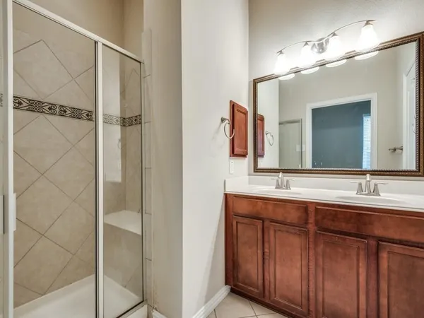 a bathroom with a double vanity sink and a mirror