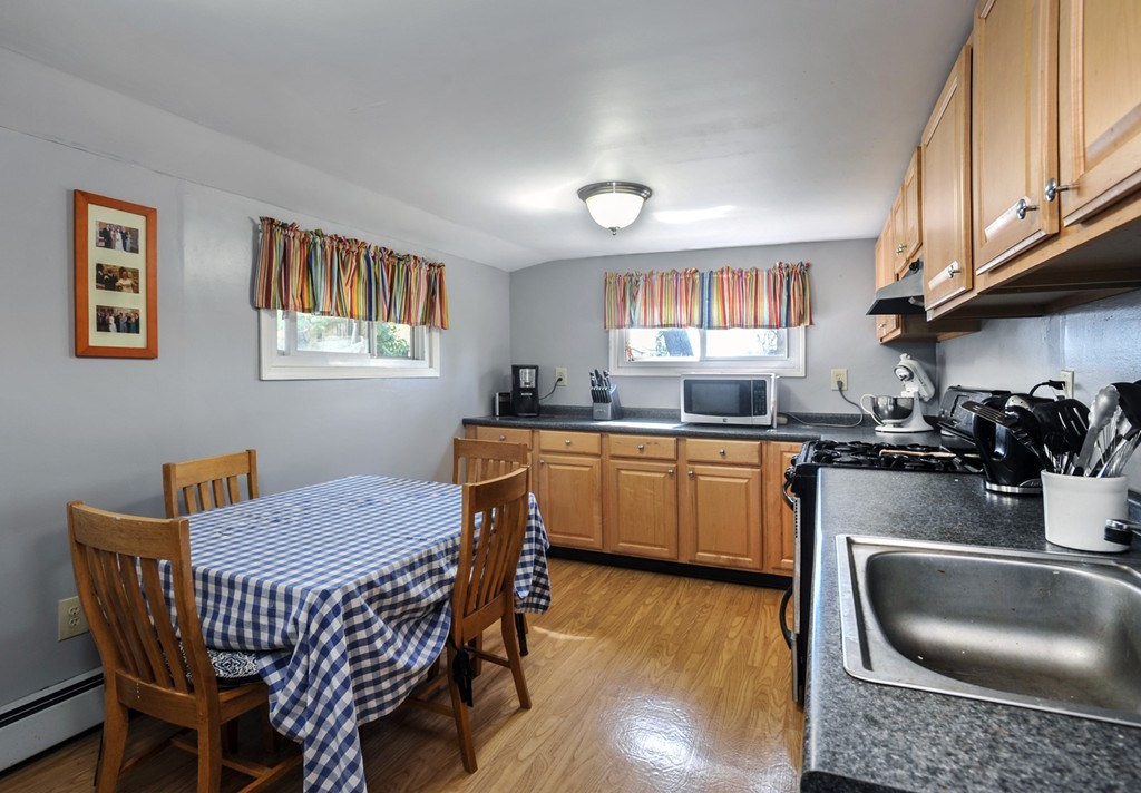 32 Colonial Road Weymouth, MA 02191 - Photo 13 of 19 a kitchen with a sink cabinets a window and stainless steel appliances