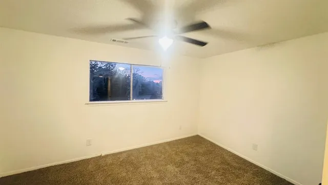 an empty room with a hallway and a mirror