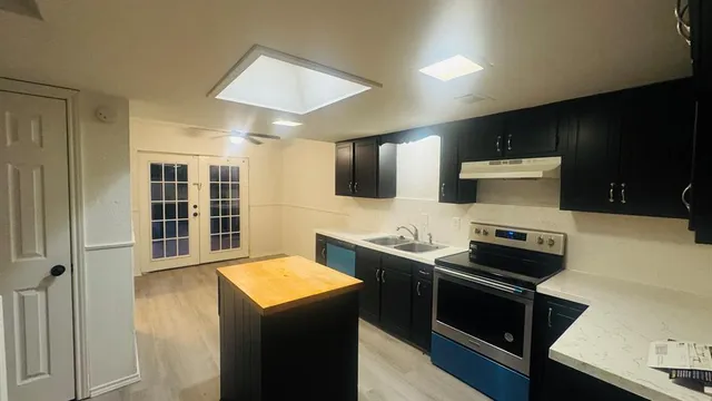 a view of a hallway with a ceiling fan