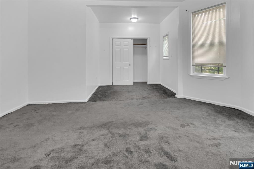 54 3rd Street, Unit 3 Newark, NJ 07107 - Photo 12 of 15 an empty room with windows and closet