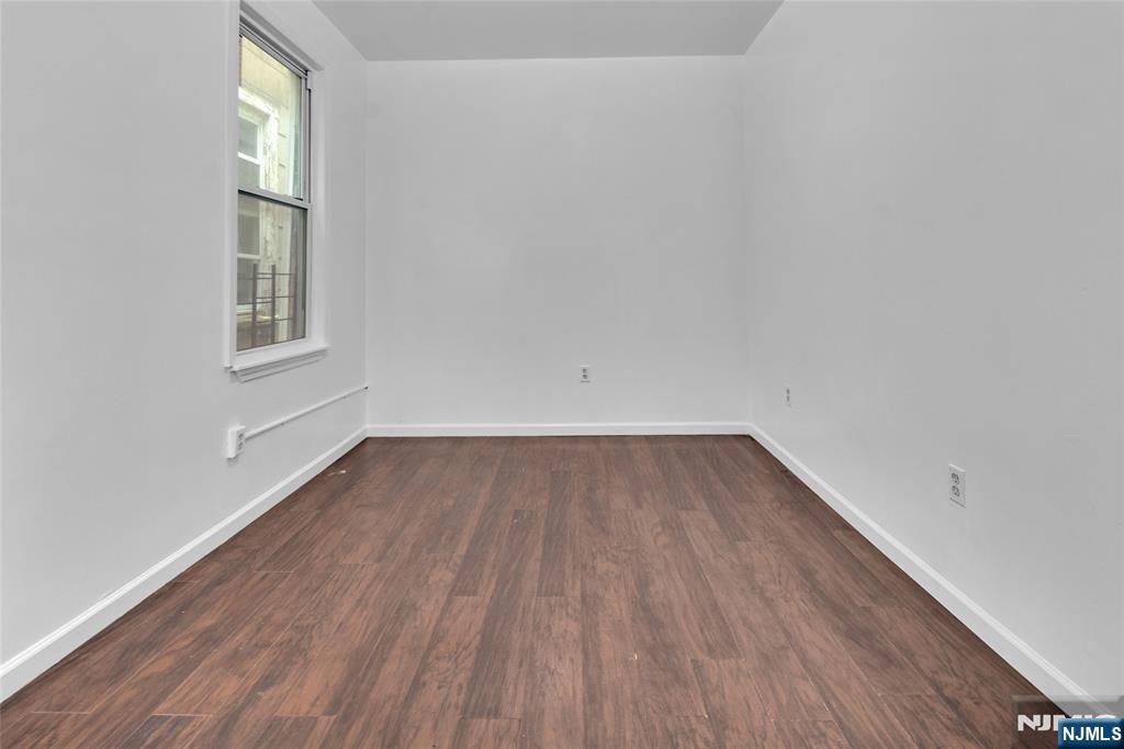 54 3rd Street, Unit 3 Newark, NJ 07107 - Photo 6 of 15 a view of an empty room and wooden floor