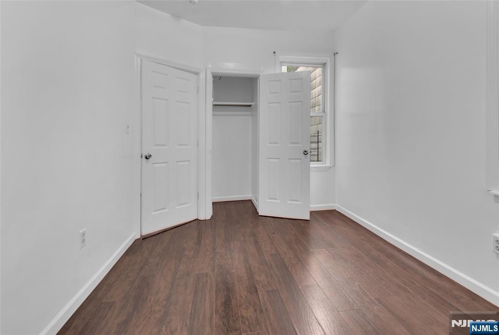 54 3rd Street, Unit 3 Newark, NJ 07107 - Photo 8 of 15 a view of an empty room with wooden floor and closet