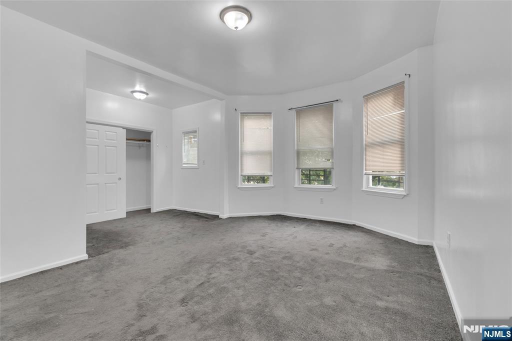 54 3rd Street, Unit 3 Newark, NJ 07107 - Photo 9 of 15 an empty room with windows and closet