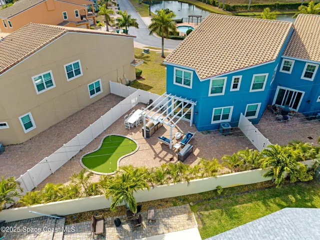an aerial view of a house with a swimming pool