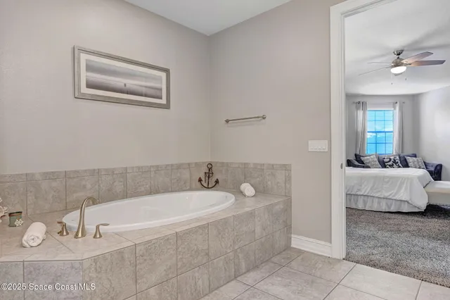 a living room with furniture a flat screen tv and kitchen view