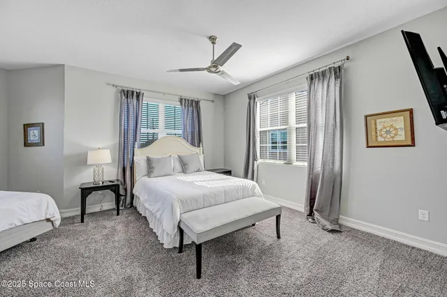 a bedroom with two beds and painted walls