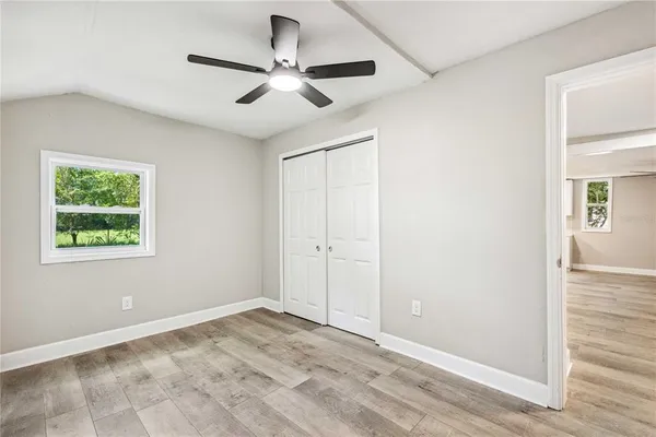 a view of a livingroom with a ceiling fan and window