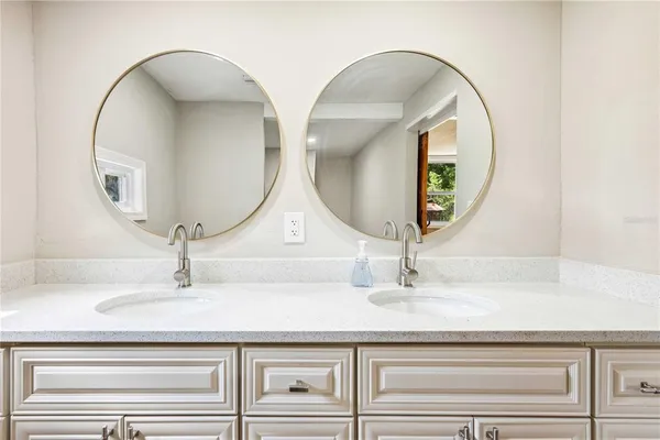 a bathroom with a granite countertop and mirror