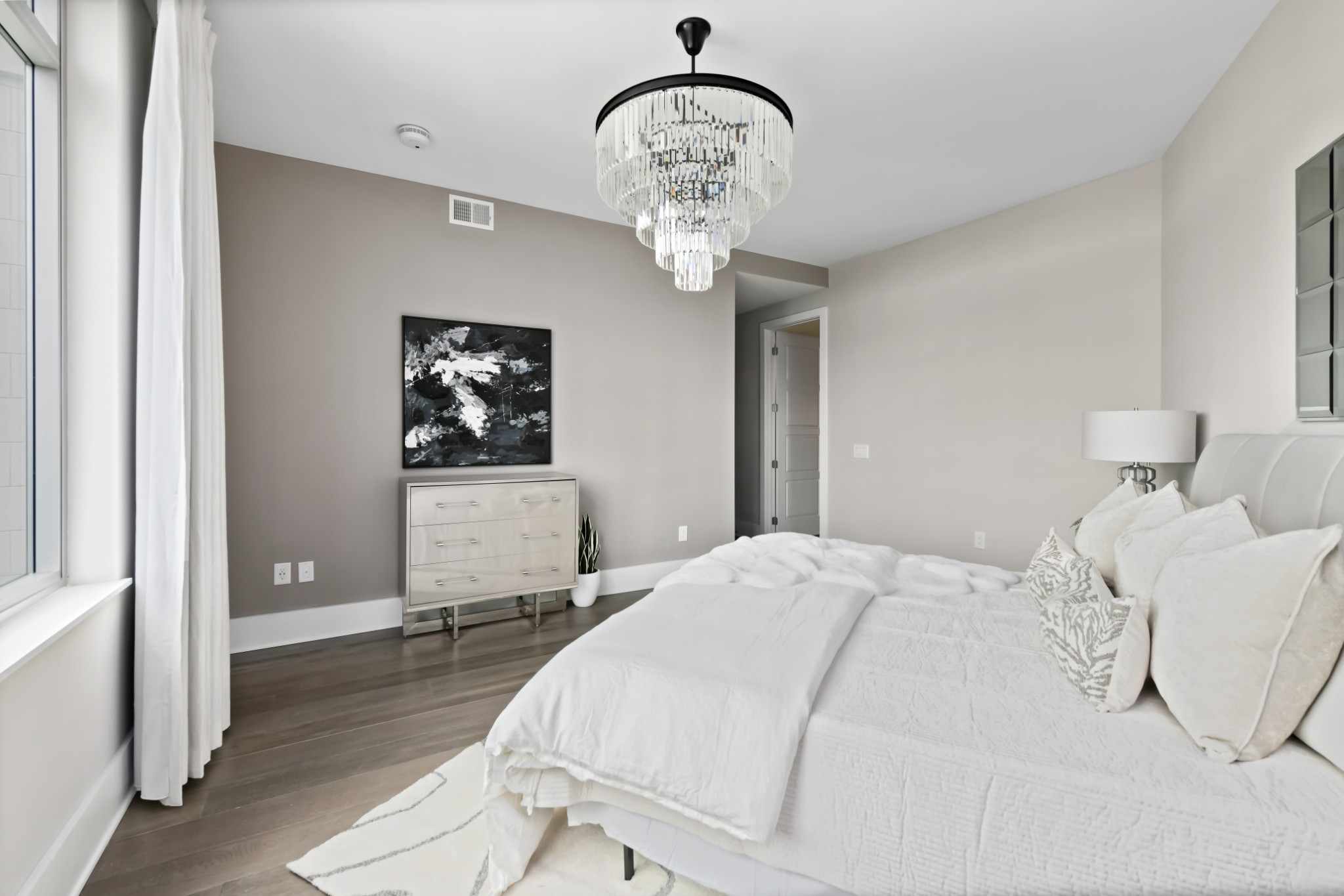 20 Rutledge Street, Unit 707 Nashville, TN 37210 - Photo 12 of 51 a bedroom with a bed and a chandelier