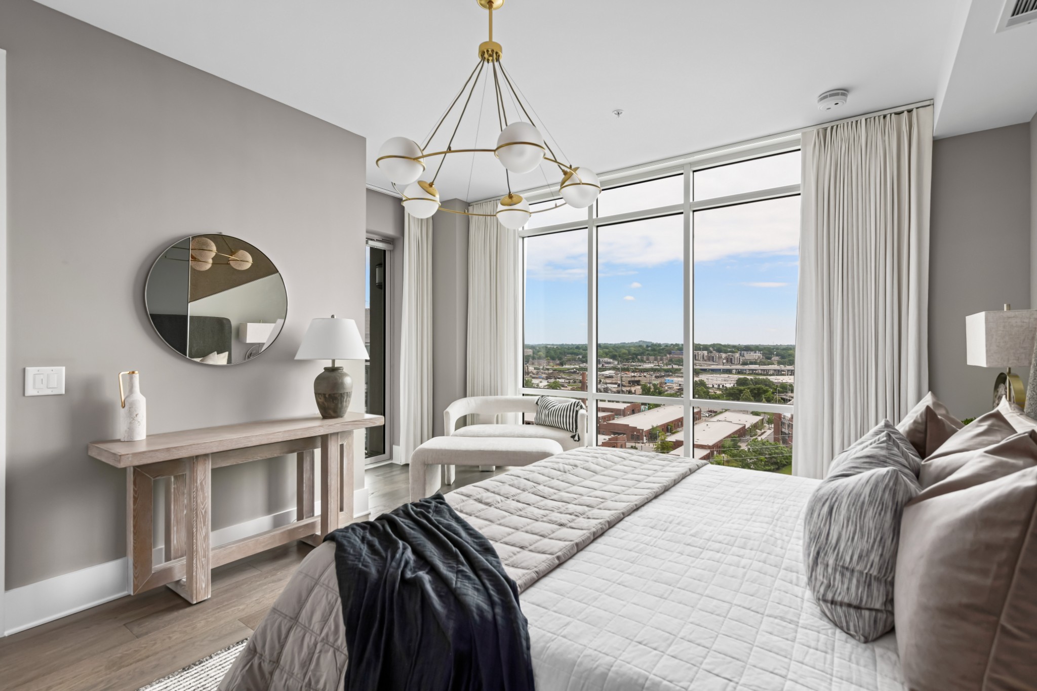20 Rutledge Street, Unit 707 Nashville, TN 37210 - Photo 19 of 51 a bedroom with a bed a chandelier and a large window
