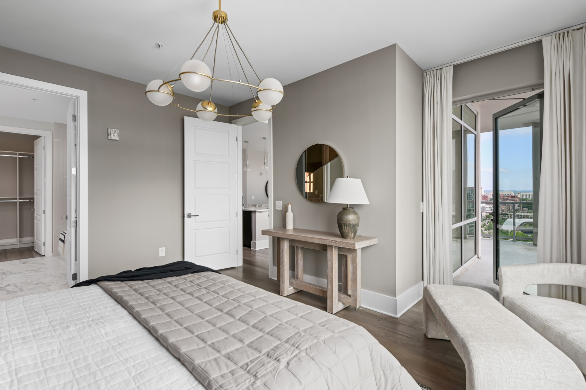 20 Rutledge Street, Unit 707 Nashville, TN 37210 - Photo 20 of 51 a bedroom with a large bed and a chandelier
