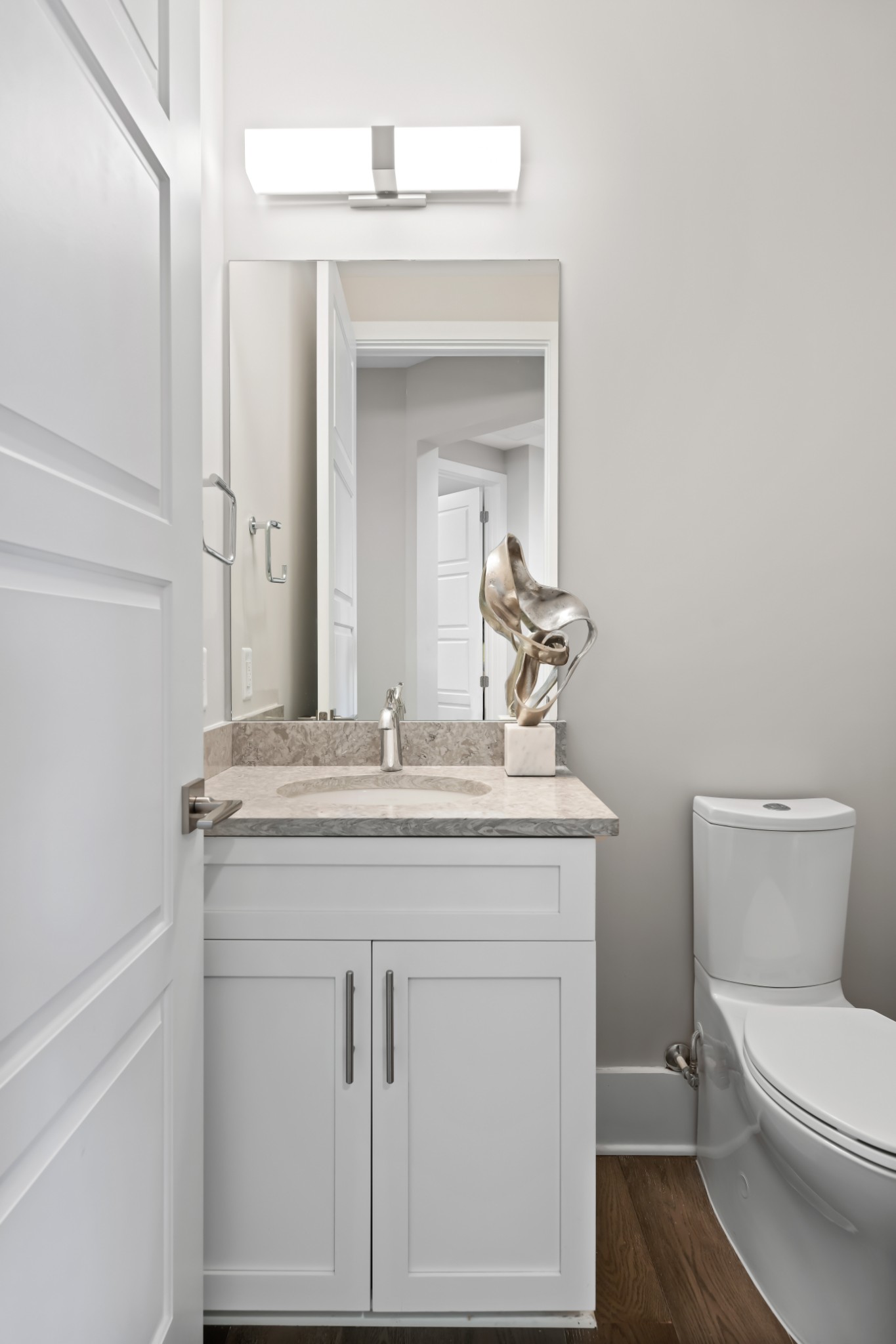 20 Rutledge Street, Unit 707 Nashville, TN 37210 - Photo 31 of 51 a bathroom with a granite countertop toilet a sink and a mirror