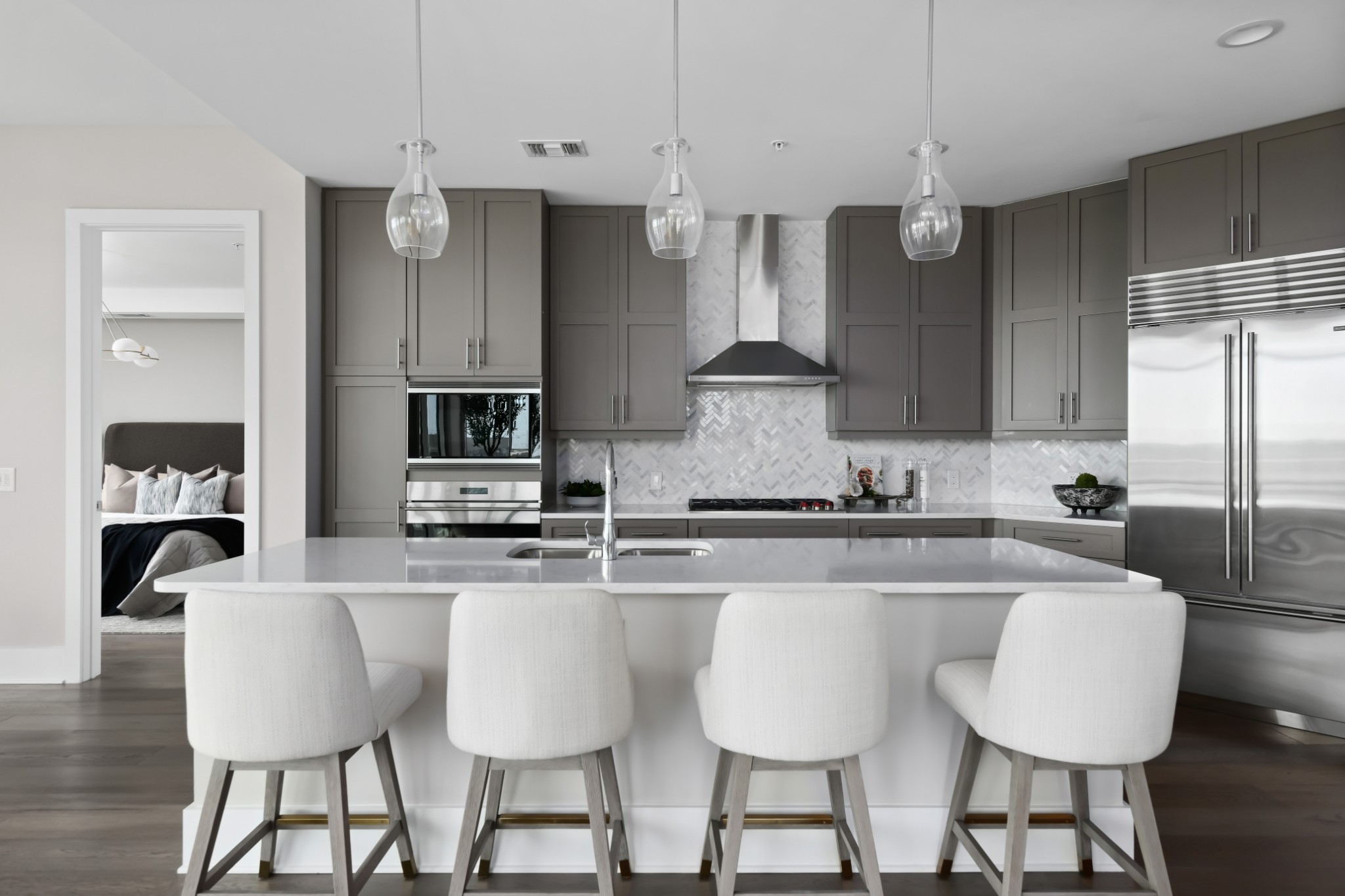 20 Rutledge Street, Unit 707 Nashville, TN 37210 - Photo 6 of 51 a kitchen with stainless steel appliances granite countertop a sink a stove a refrigerator cabinets and chairs