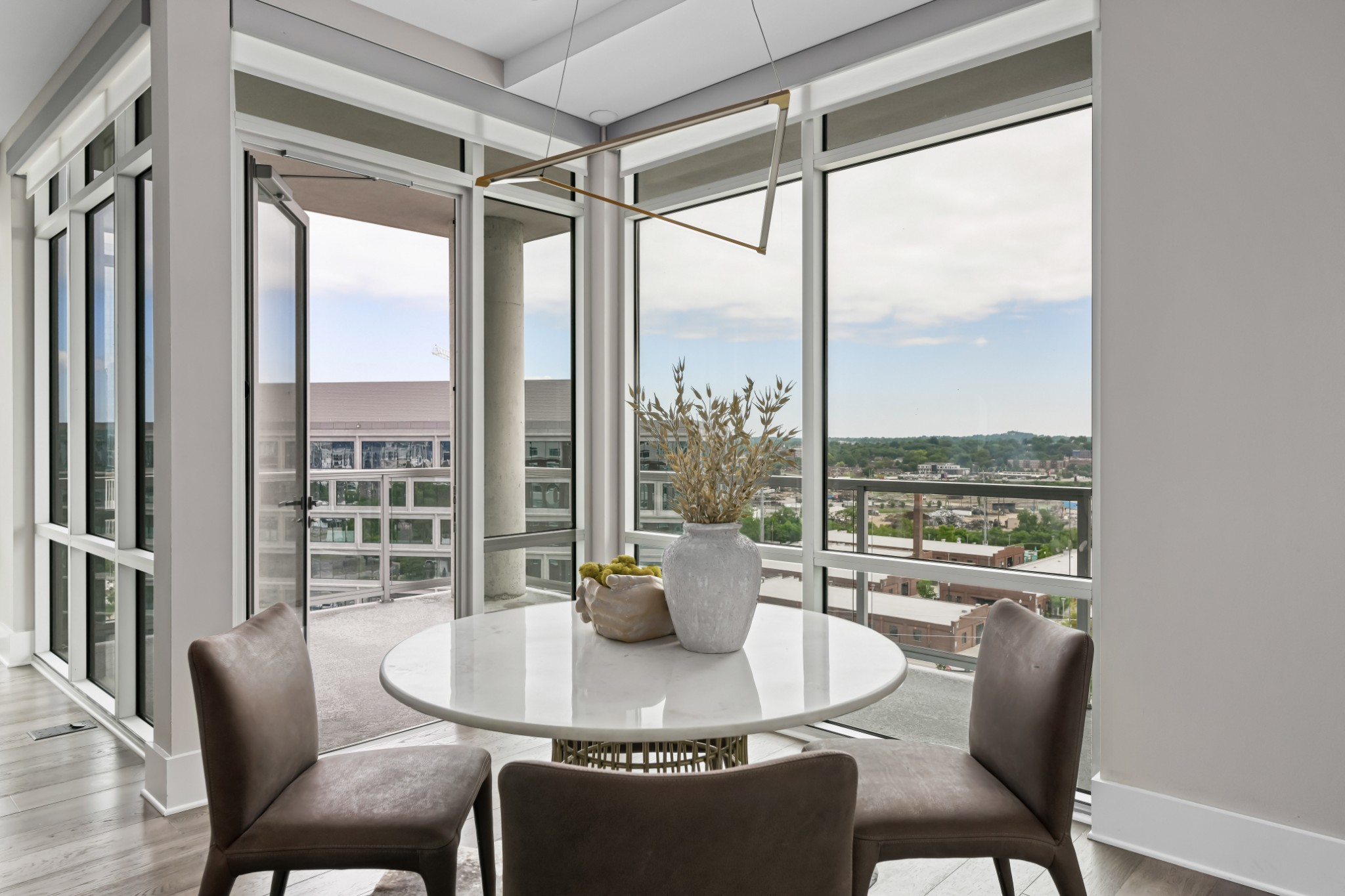 20 Rutledge Street, Unit 707 Nashville, TN 37210 - Photo 9 of 51 a dining room with furniture large windows and wooden floor
