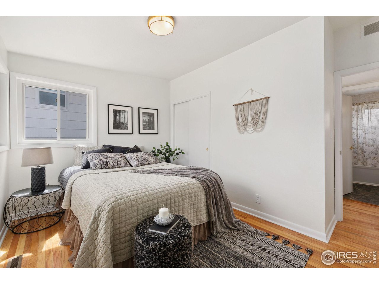 533 Crestmore Place Fort Collins, CO 80521 - Photo 11 of 19 a bedroom with a bed and wooden floor