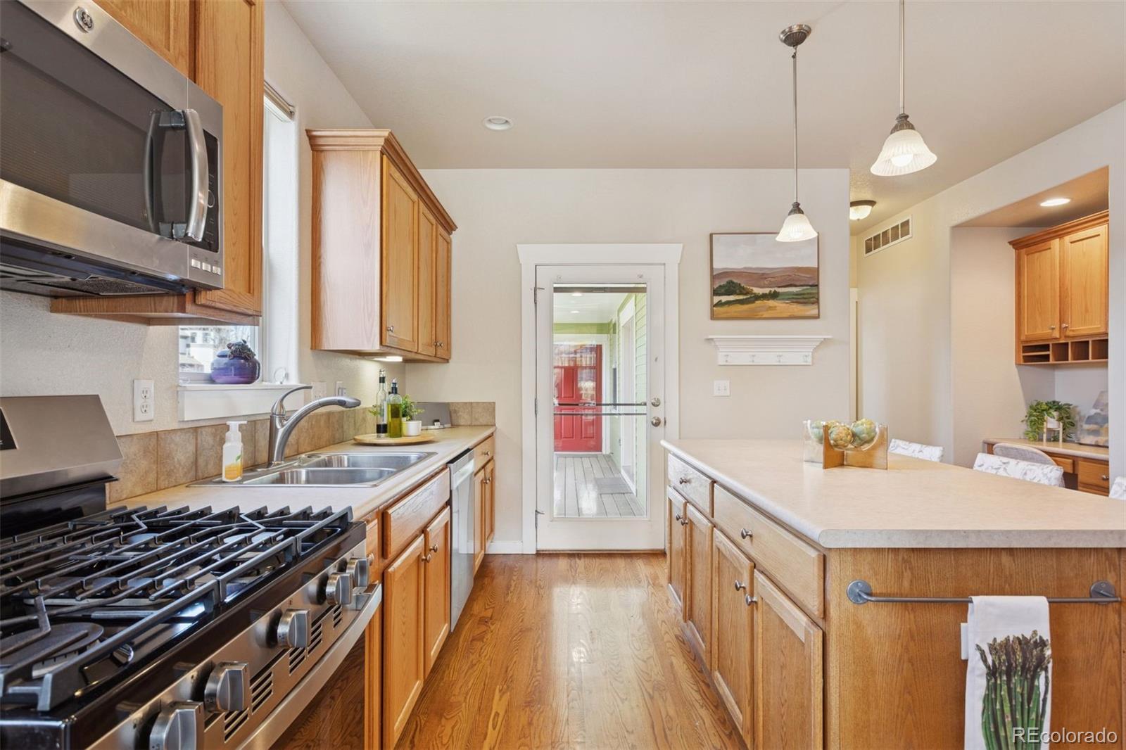 2882 Alton Street Denver, CO 80238 - Photo 11 of 42 a kitchen with a stove a sink and a microwave