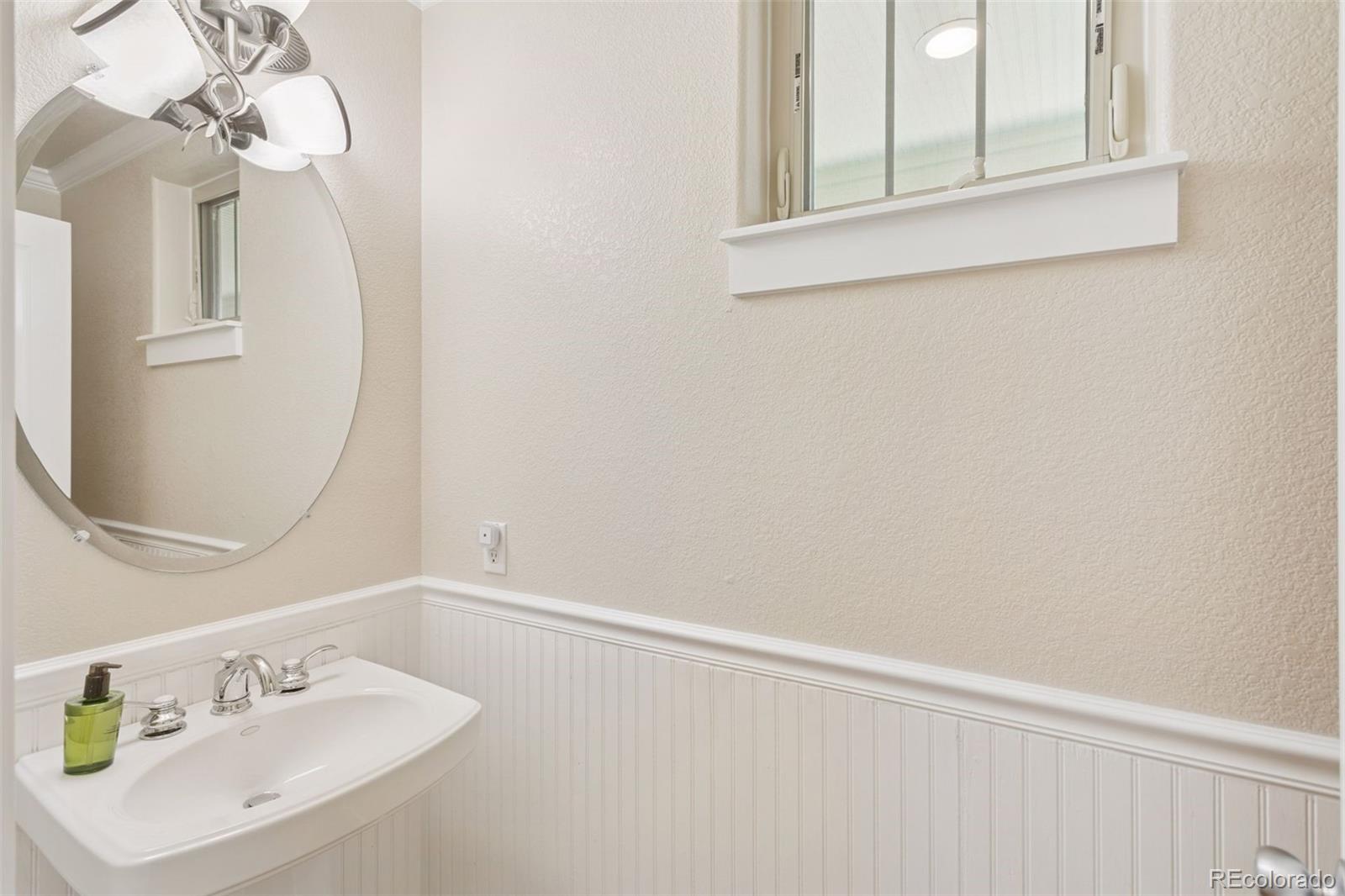 2882 Alton Street Denver, CO 80238 - Photo 13 of 42 a bathroom with a sink and a mirror