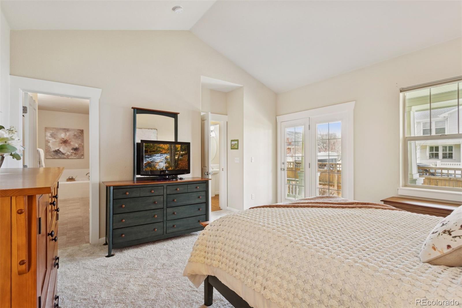 2882 Alton Street Denver, CO 80238 - Photo 15 of 42 a bedroom with a bed and a television