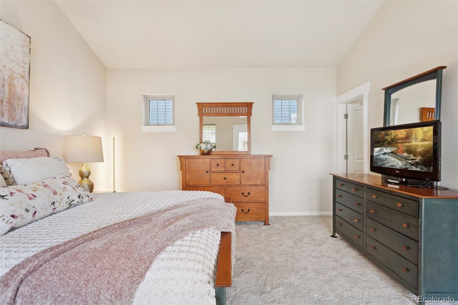 2882 Alton Street Denver, CO 80238 - Photo 16 of 42 a bedroom with a bed and a flat screen tv