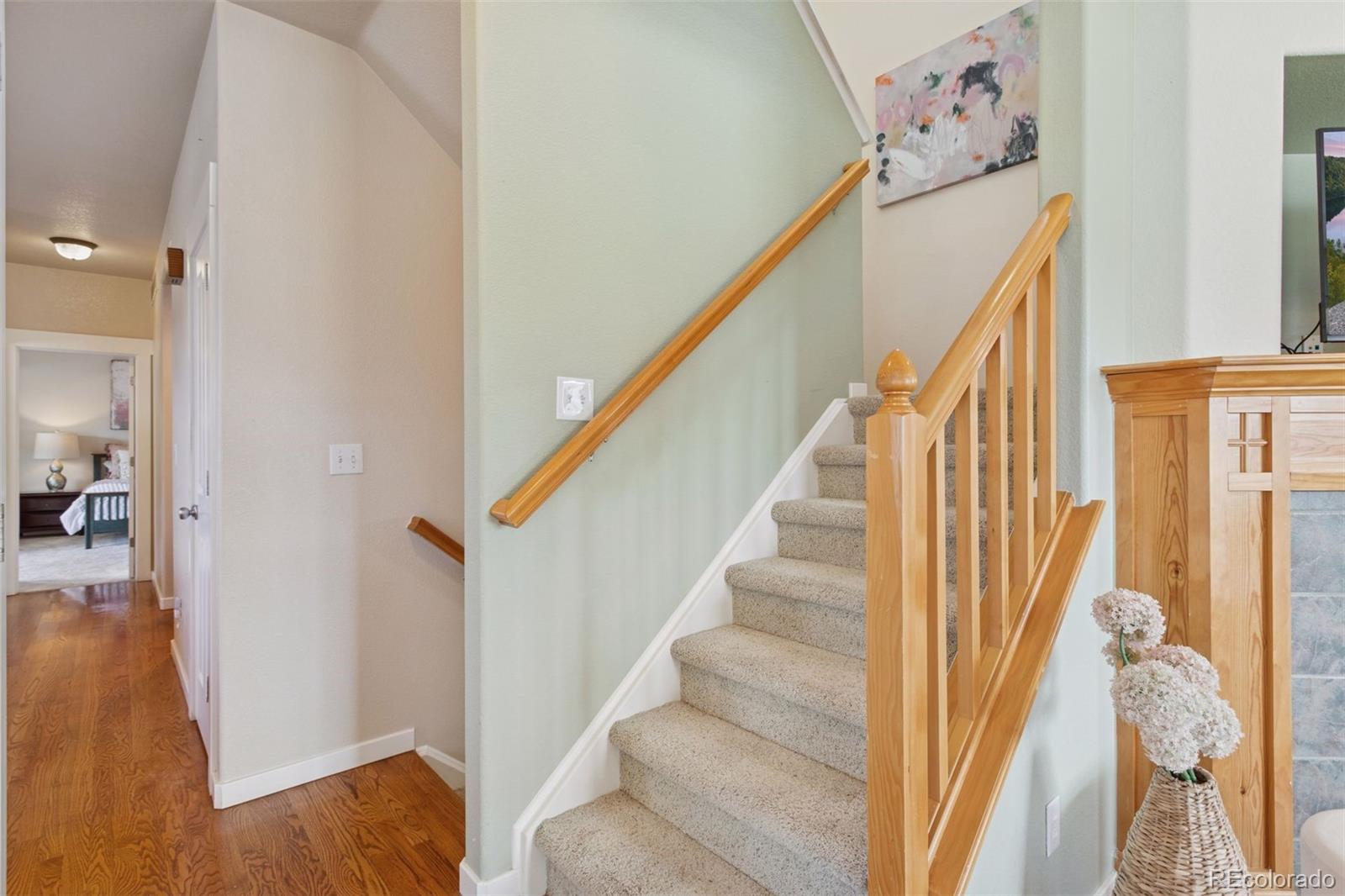 2882 Alton Street Denver, CO 80238 - Photo 19 of 42 a view of a hallway with wooden floor and stairs