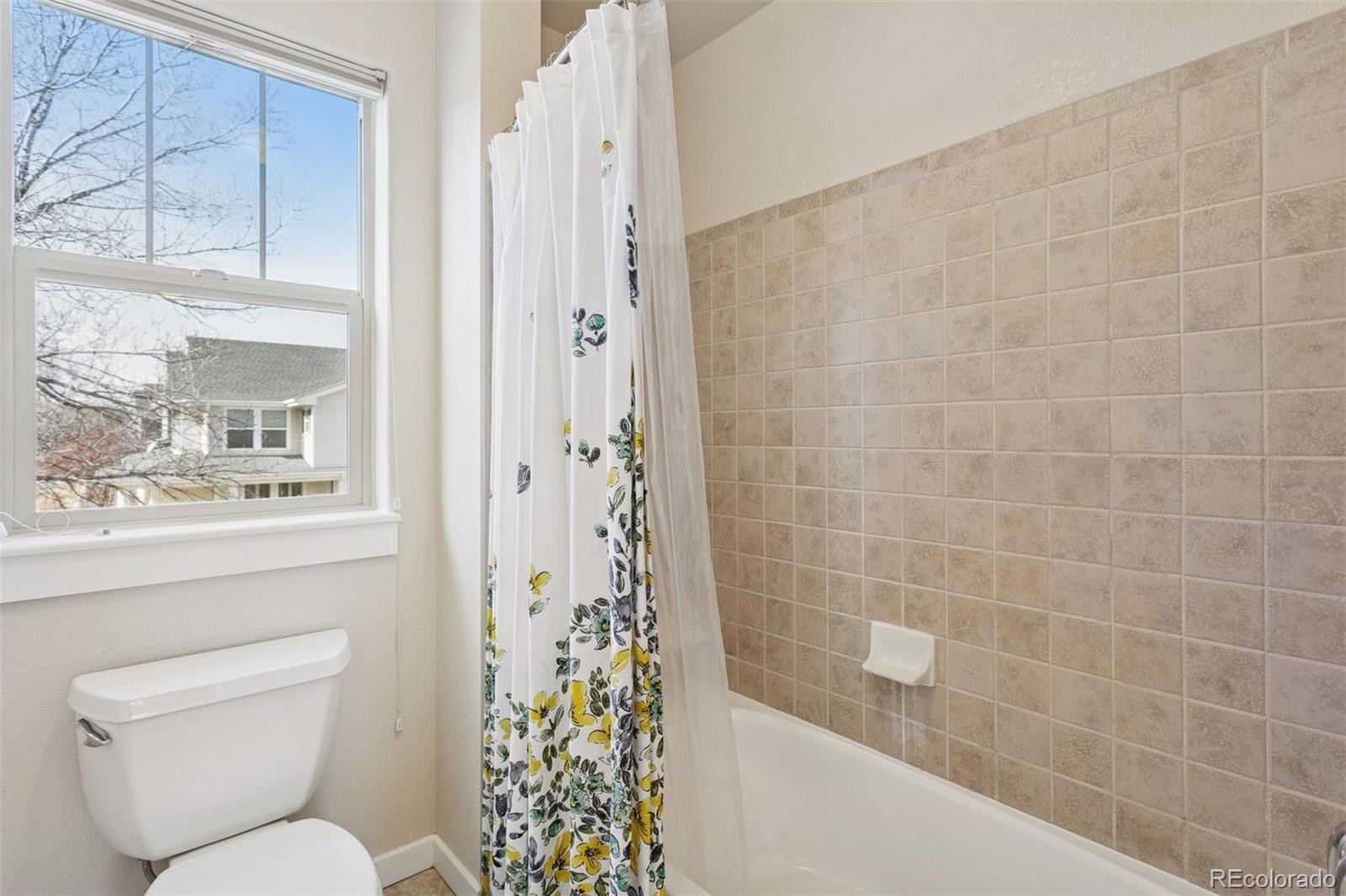 2882 Alton Street Denver, CO 80238 - Photo 23 of 42 a bathroom with a toilet and shower