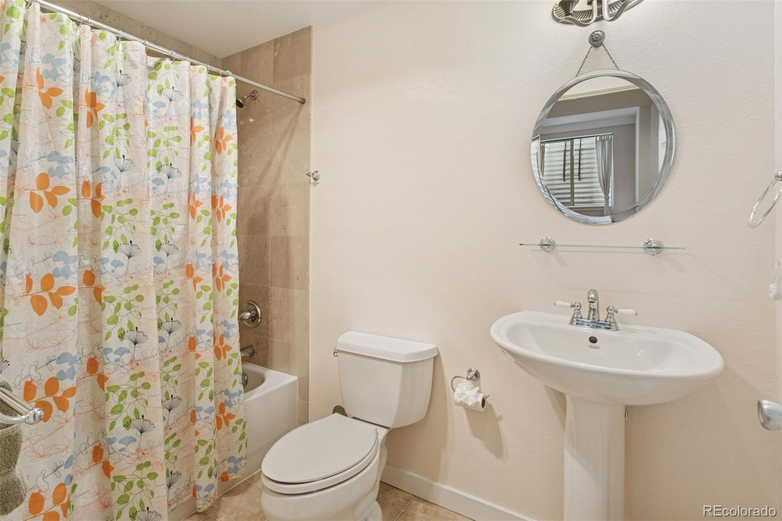 2882 Alton Street Denver, CO 80238 - Photo 34 of 42 a bathroom with a sink a mirror a toilet and a window