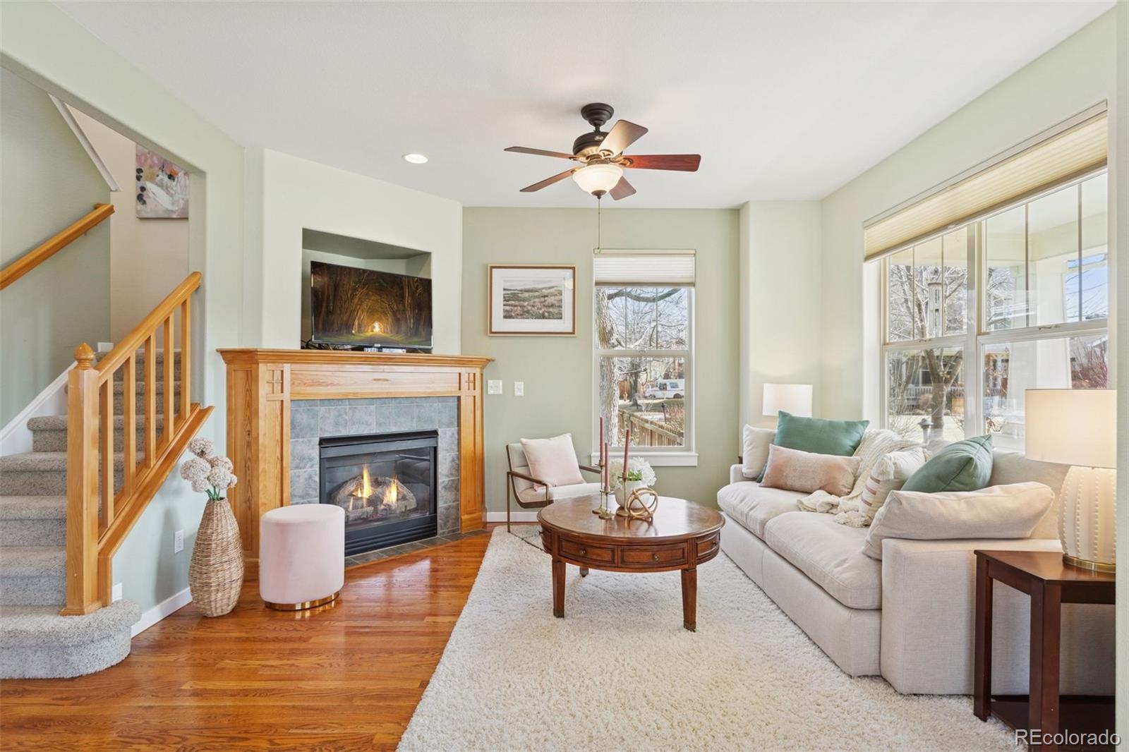 2882 Alton Street Denver, CO 80238 - Photo 5 of 42 a living room with furniture a fireplace and a flat screen tv