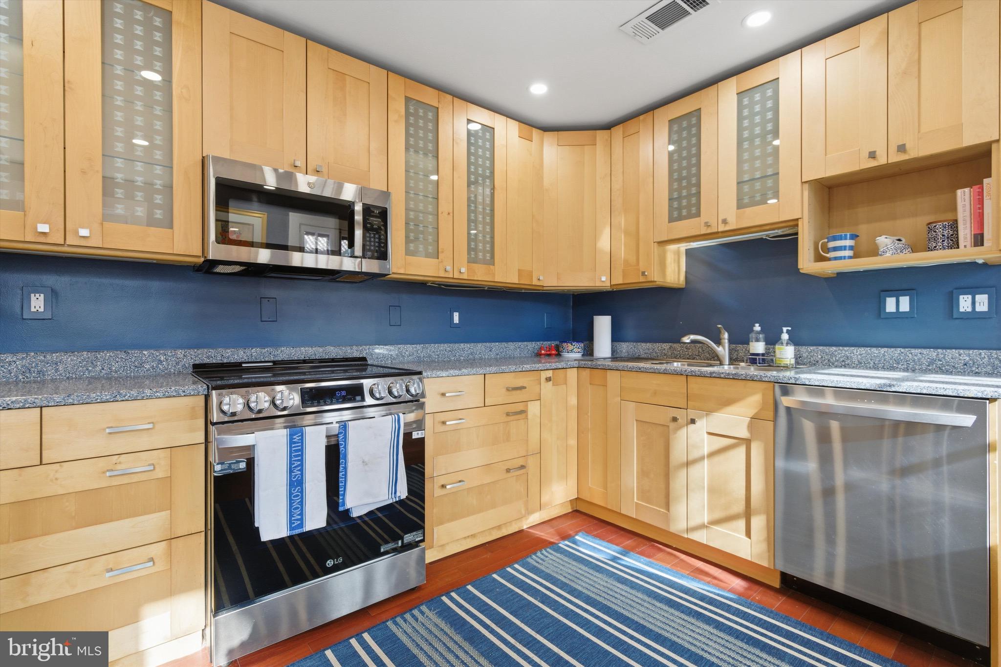 230 Stony Run Lane, Unit 4F Baltimore, MD 21210 - Photo 14 of 24 a kitchen with stainless steel appliances granite countertop a stove a sink and a microwave