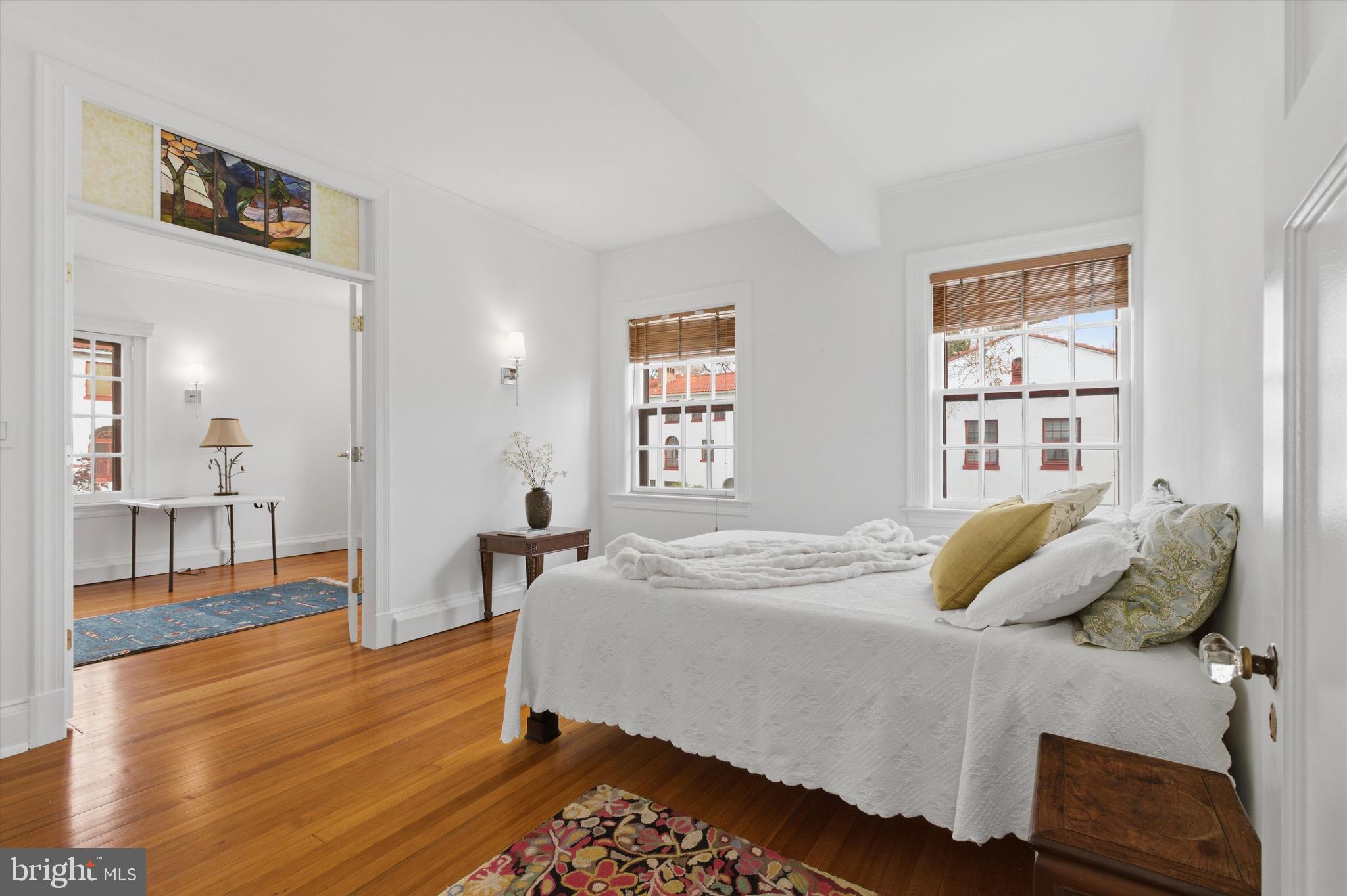 230 Stony Run Lane, Unit 4F Baltimore, MD 21210 - Photo 19 of 24 a bedroom with a bed and wooden floor