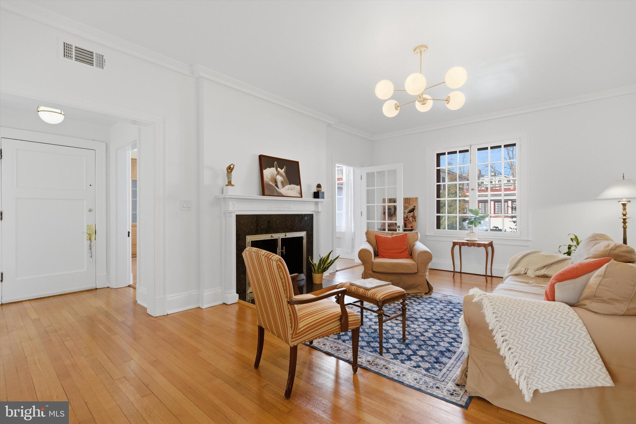230 Stony Run Lane, Unit 4F Baltimore, MD 21210 - Photo 6 of 24 a living room with furniture and a fireplace
