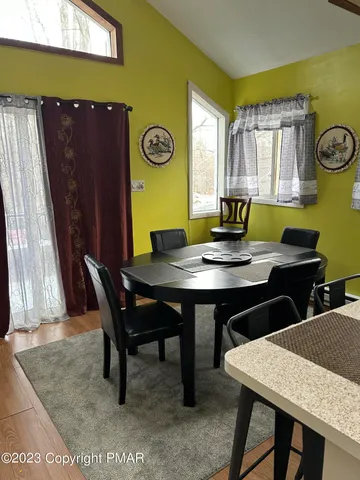 a view of a dining room with furniture and window