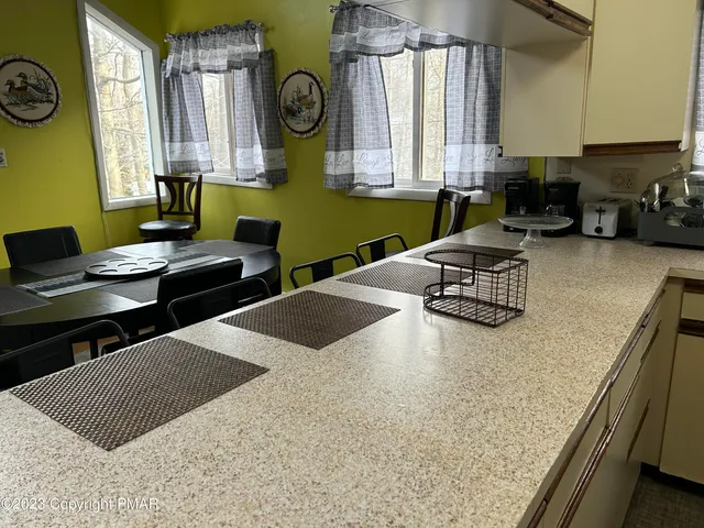 a kitchen with a stove a sink and a wooden cabinets