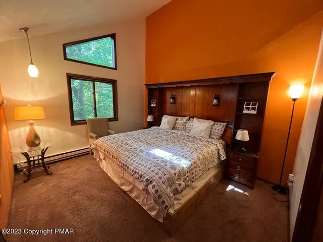 a bed sitting in a room next to a window